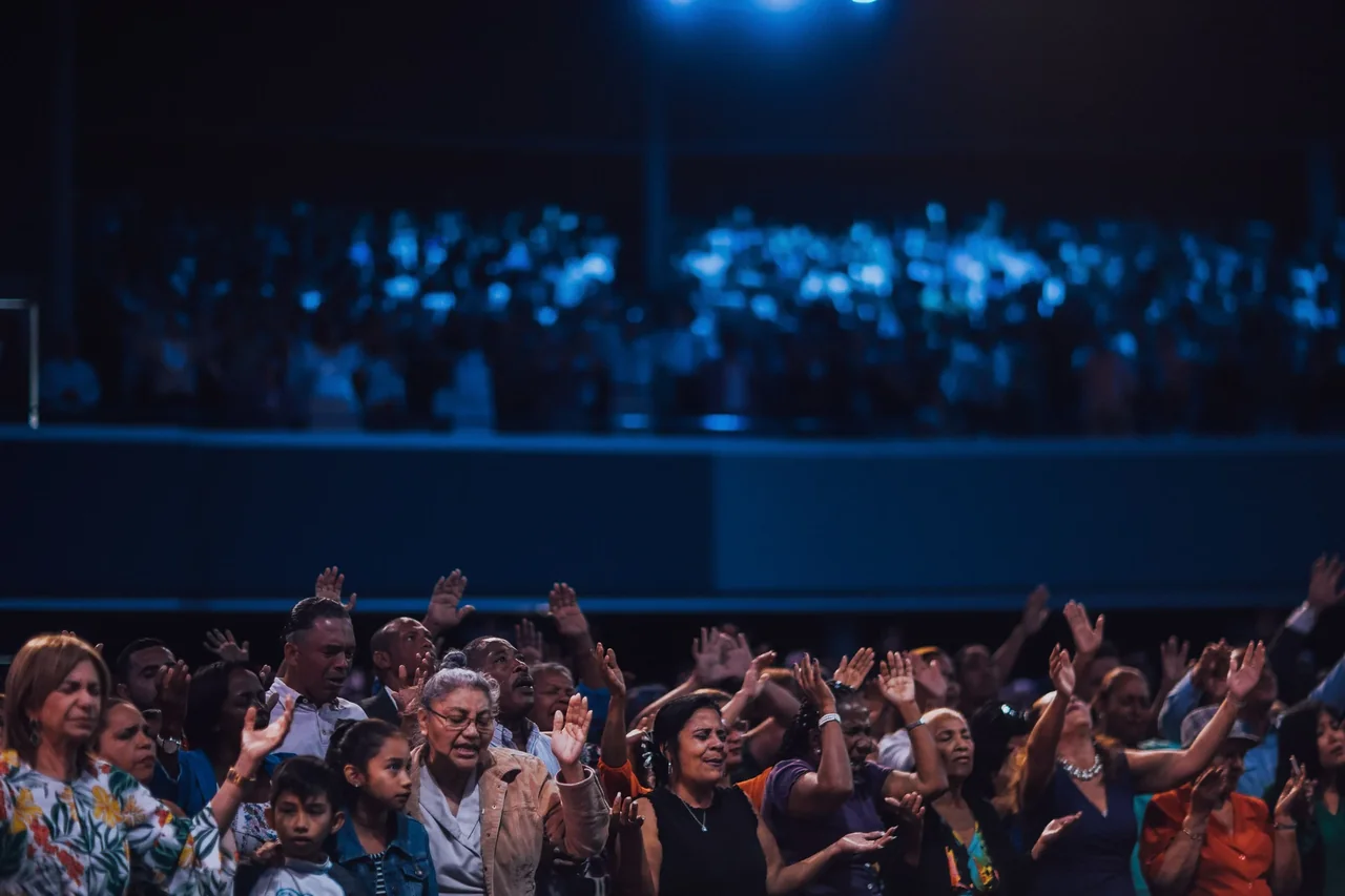 Worshippers raising their hands during a church service